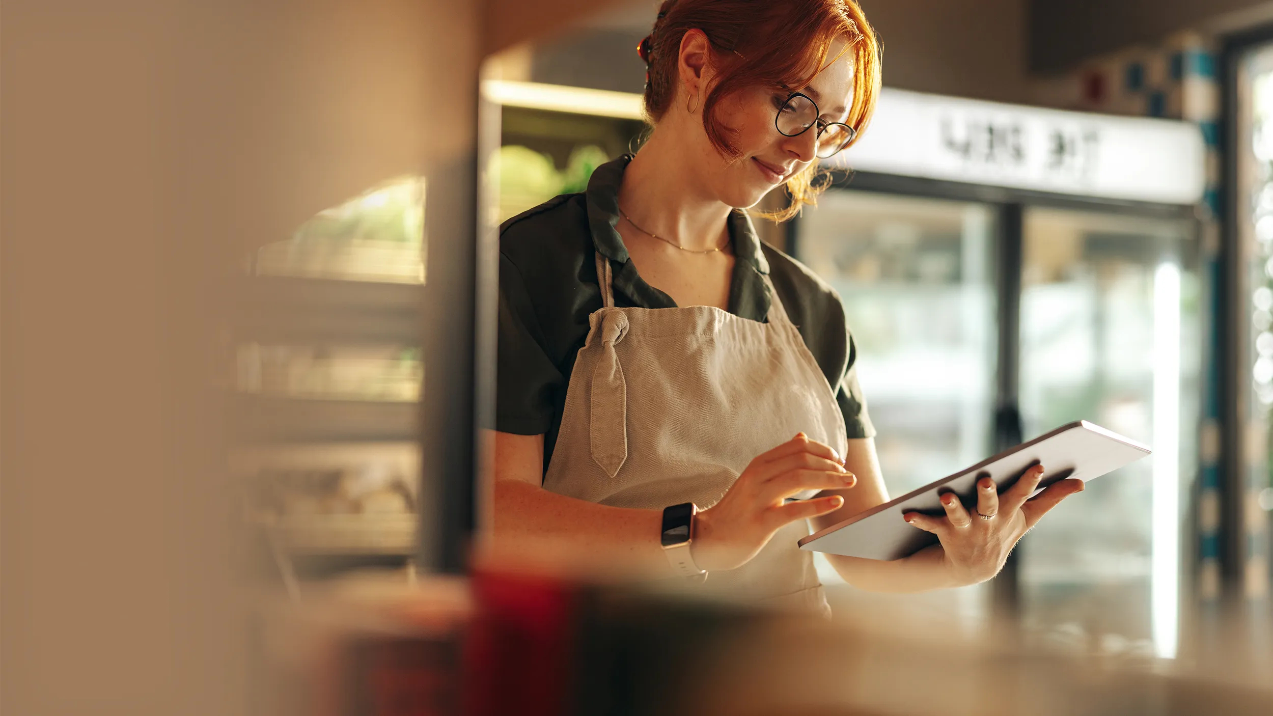 employée d'une épicerie qui travaille sur un ipad.