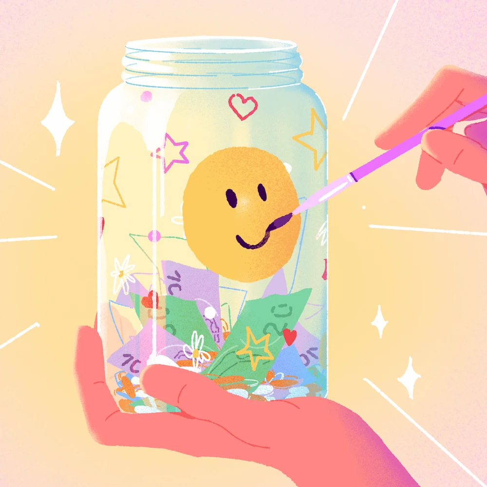 A hand painting a smiley face on a tip jar that is filled with coins and bills, symbolizing creative and welcoming tip jar ideas.