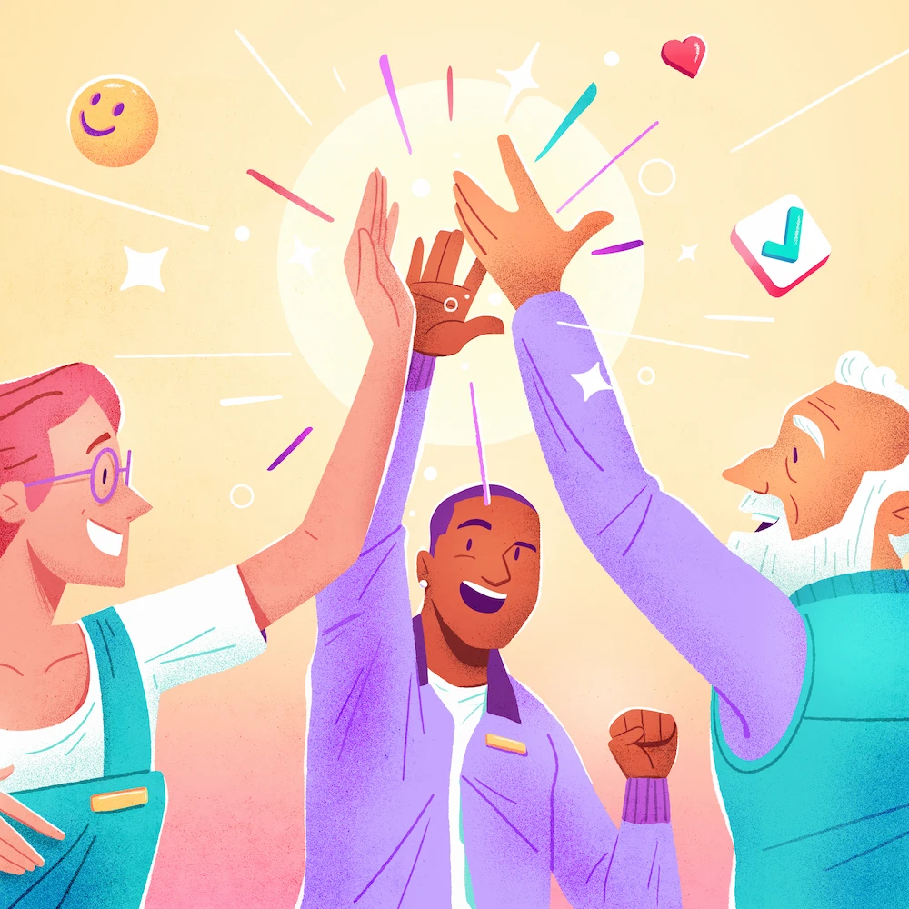 Three employees forming a multigenerational team high-five each other. The group is in a warehouse.