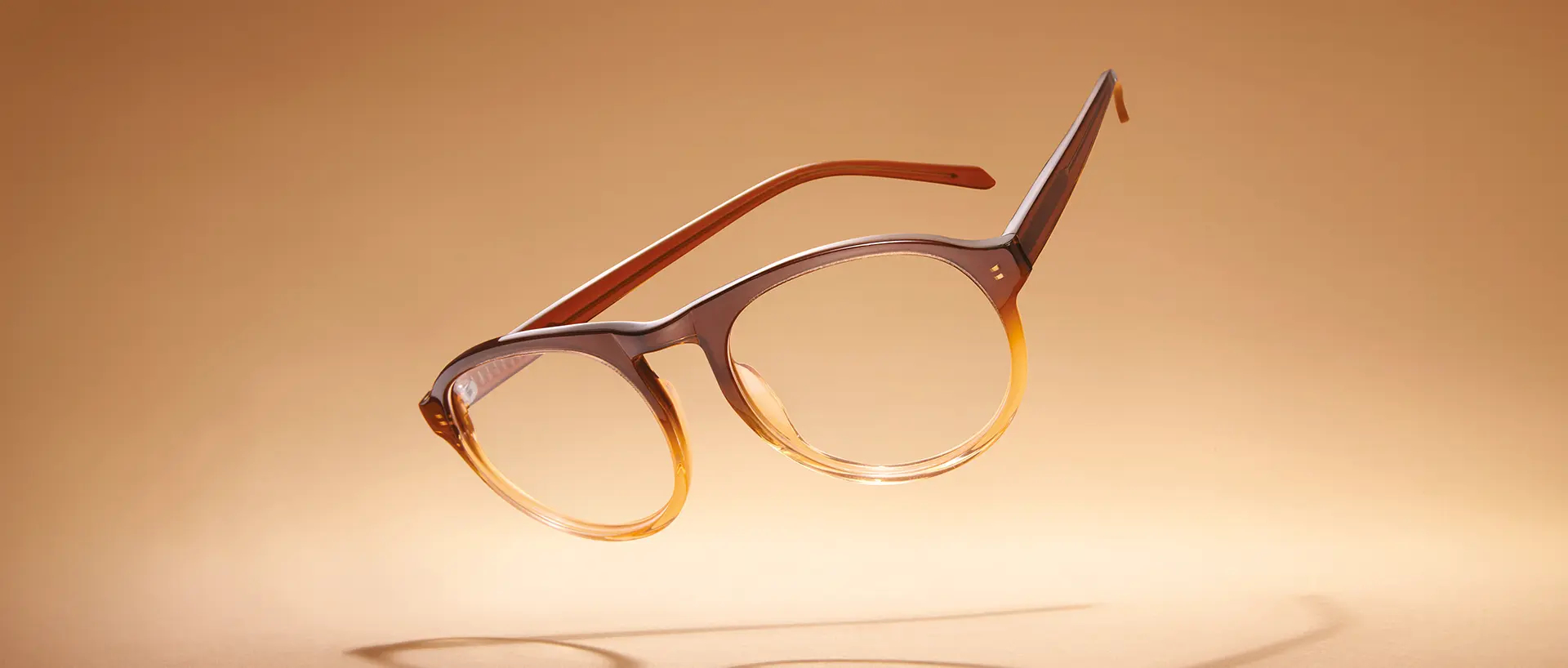 A pair of trendy glasses floating on a luminous background