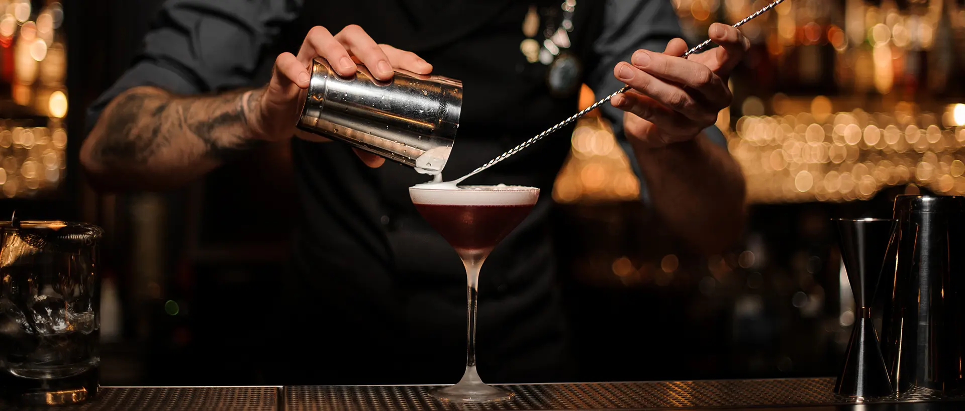 A barman prepares a cocktail in a club