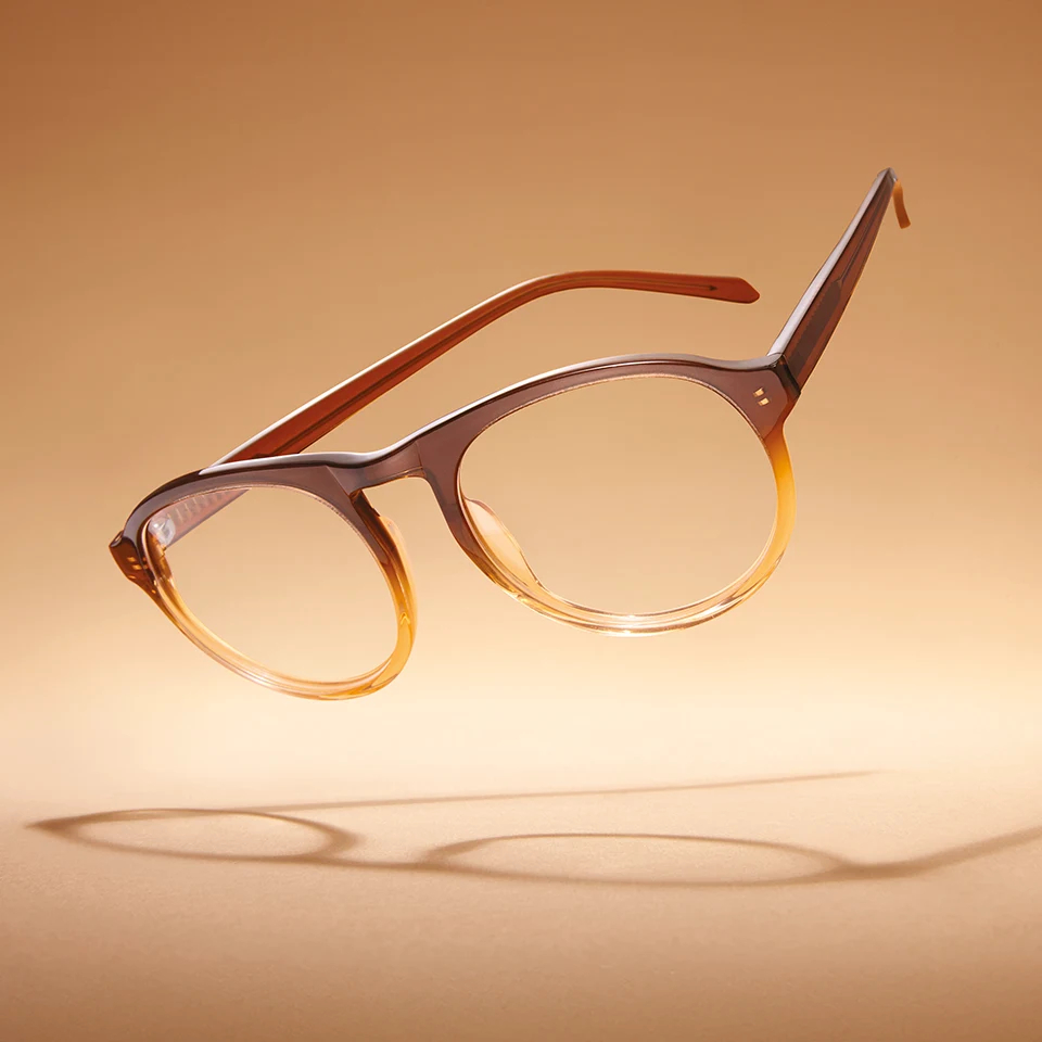 A pair of trendy glasses floating on a luminous background